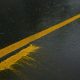 Uncured roadline paint washed off by rain